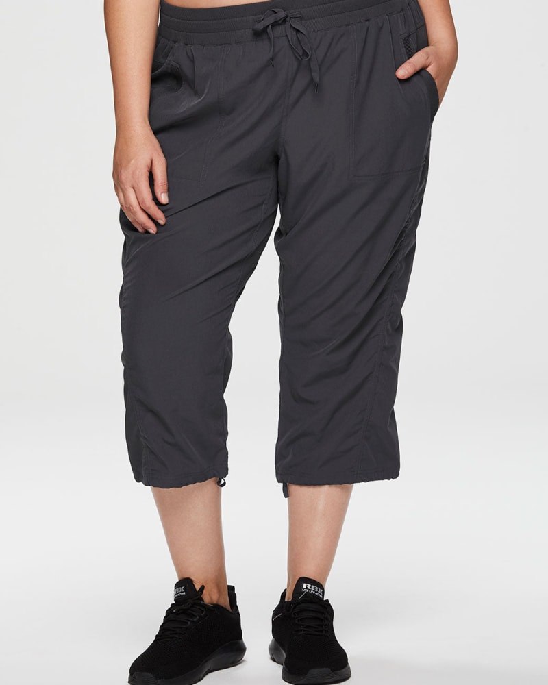 Front of a model wearing a size 1X Lumen Lightweight Capri Pant in Charcoal by RBX Active. | dia_product_style_image_id:244706